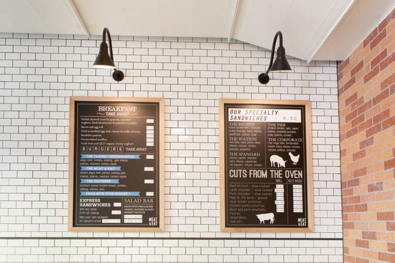 two black sign lights over menu boards
