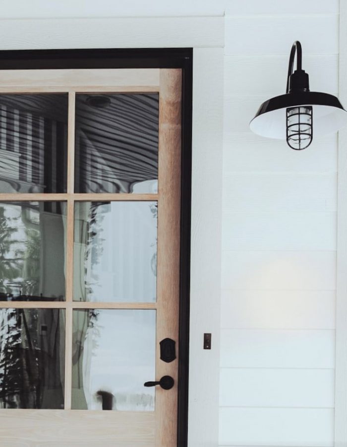 Black Outdoor Wall Mounted Barn Light in Black Gloss w/ Timber Framed Door with white washed exterior