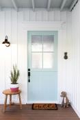 Pale blue door with white vertically ribbed walls